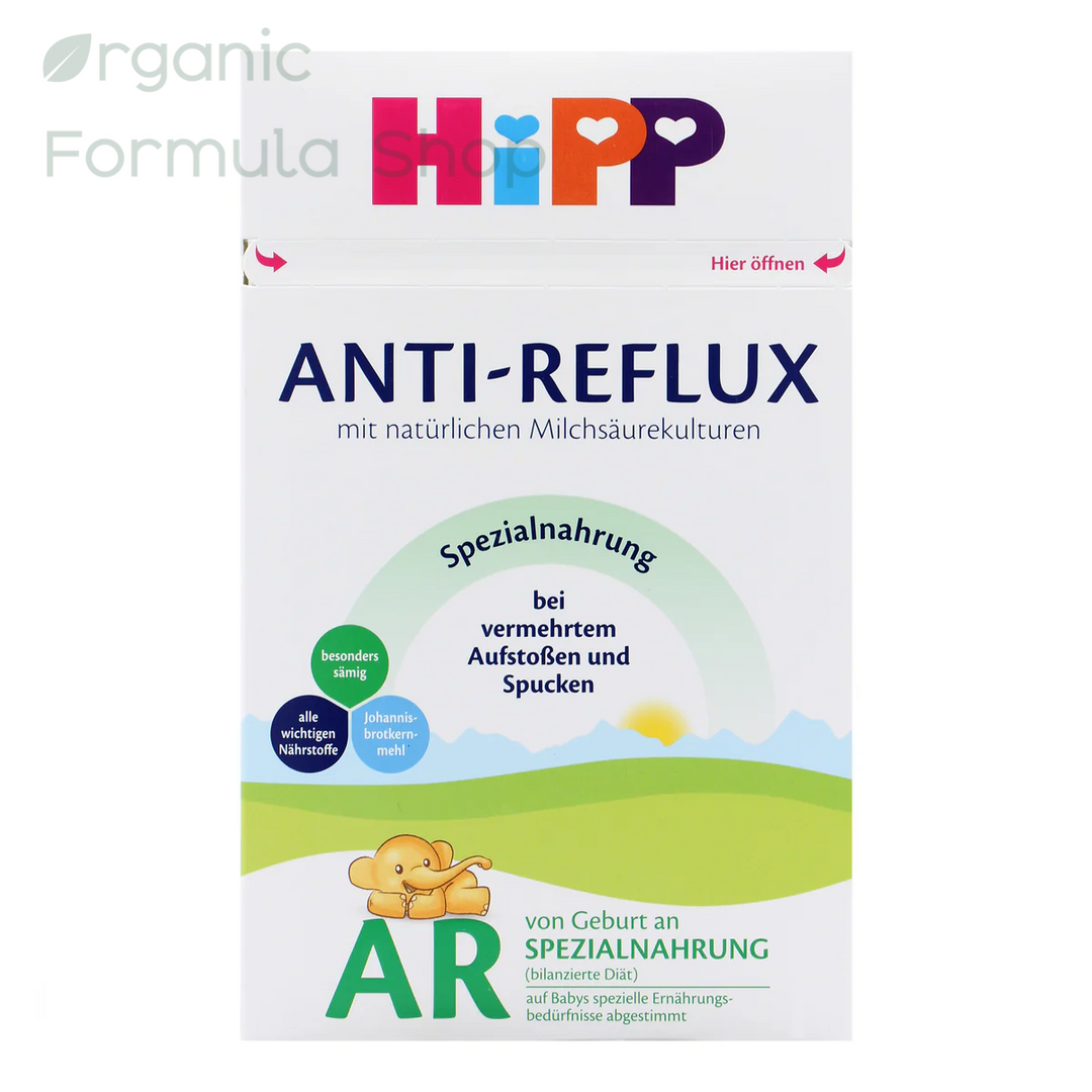 A package of HiPP Anti-Reflux Special Nutrition infant formula powder. The white box features the colorful HiPP logo at the top, dark blue text for 'ANTI-REFLUX', and a green and yellow landscape graphic at the bottom with a cartoon teddy bear. HiPP German Anti-Reflux European organic baby formula with locust bean gum, 600g, for babies 0 months and older