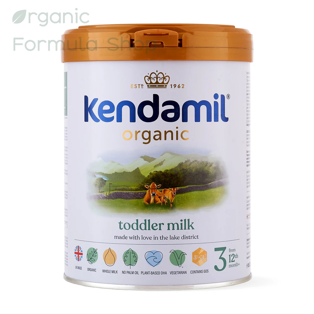 A canister of Kendamil UK Organic Cow Stage 3 European organic palm-oil-free toddler formula in 800g tin, front of can, for toddlers 12 months and older. Featuring a white label with a green landscape illustration and an orange lid, set against a plain white background.