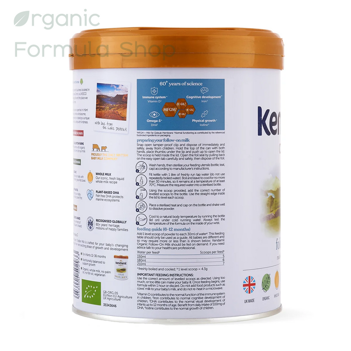 A canister of Kendamil UK Organic Cow Stage 2 European organic palm-oil-free follow-on formula in 800g tin, front of can, for babies 6 to 12 months
showing the back panel with text, ingredients, and icons, on a white background with a faint store watermark.